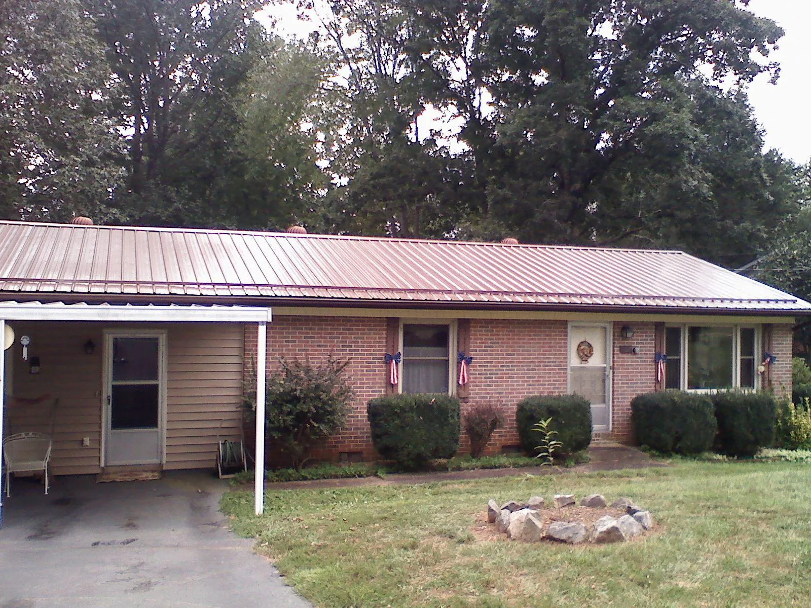 Bronze metal roof and carport on a brick ranch home — Roof Repair work by our crew in Swiftwater